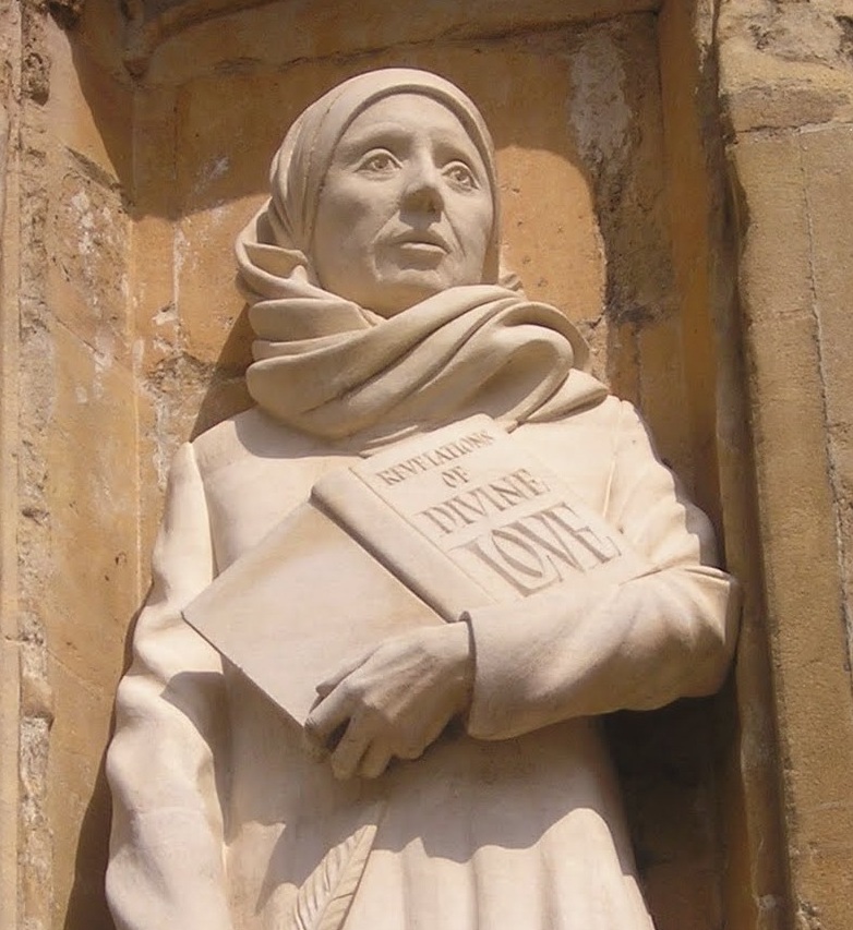 A statue of Julian of Norwich, holding her book 'Revelations of Divine Love'